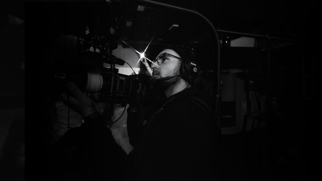 Cole Morell operating a RED Komodo camera during a live worship recording at a megachurch, founder of Layout Media and creative filmmaker based in California
